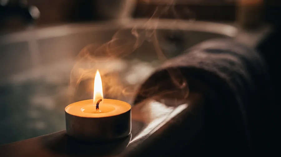 person relaxing in a warm bath with dim lighting as part of an evening wind-down routine