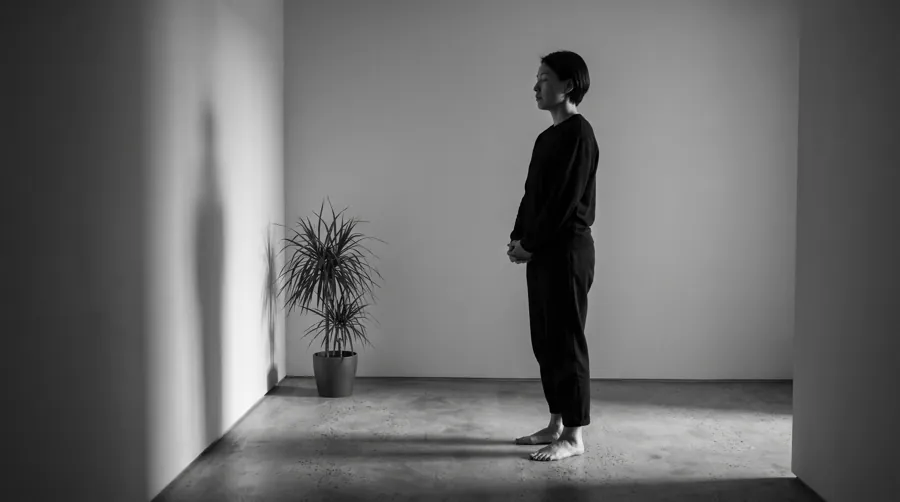 person pausing at their front door practicing slow transitions as part of a slow living routine